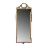 A GILTWOOD AND GESSO WALL MIRROR, 20TH CENTURY, the shaped plate within a beaded moulded and