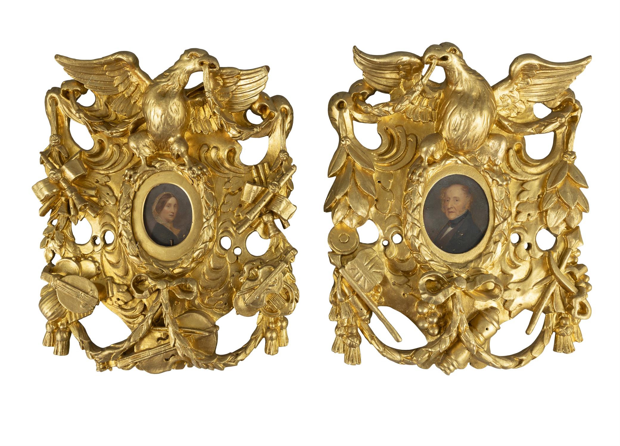 TWO GILTWOOD AND GESSO PIERCED CARVED FRAMES, each with central oval picture opening in the