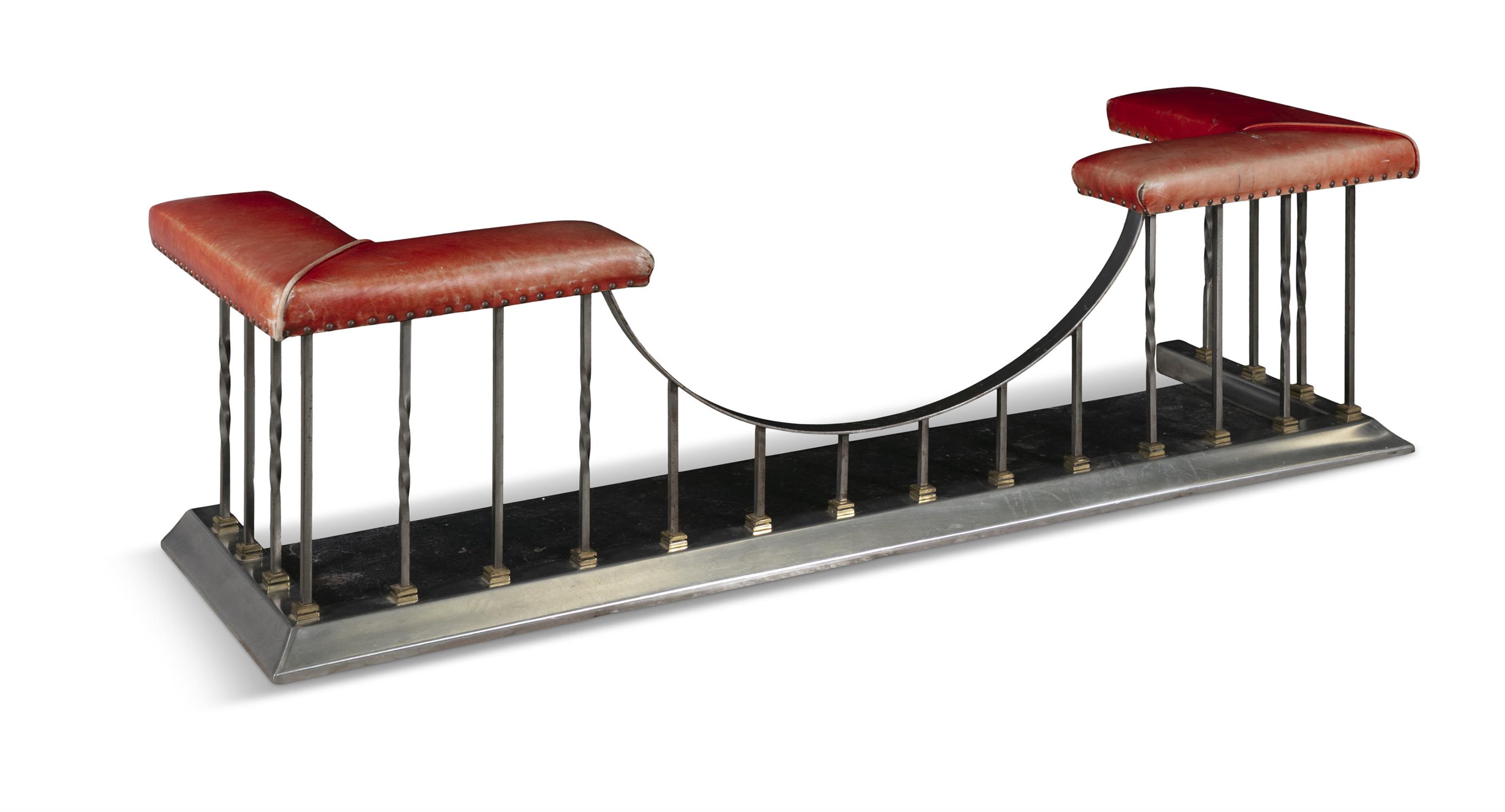 A 20TH CENTURY STEEL FRAME CLUB FENDER, with close nail padded seats, upholstered in red