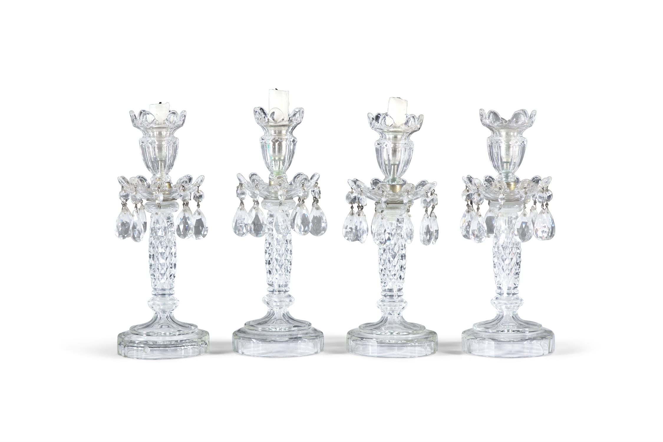 A SET OF FOUR CUT AND MOULDED GLASS LUSTRE CANDLESTICKS, 20TH CENTURY, each with flared socket