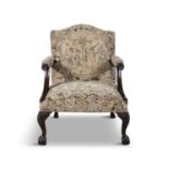 A GEORGE III MAHOGANY FRAMED GAINSBOROUGH ARMCHAIR the arched padded back and seat covered in a