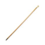 *A WOODEN WALKING CANE, with carved ivory handle in the shape of a fist enclosing a seal,