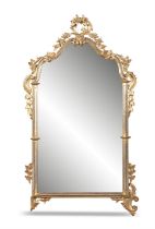 A CONTINENTAL GILTWOOD MIRROR, LATE 19TH/EARLY 20TH CENTURY the shaped plate flanked by