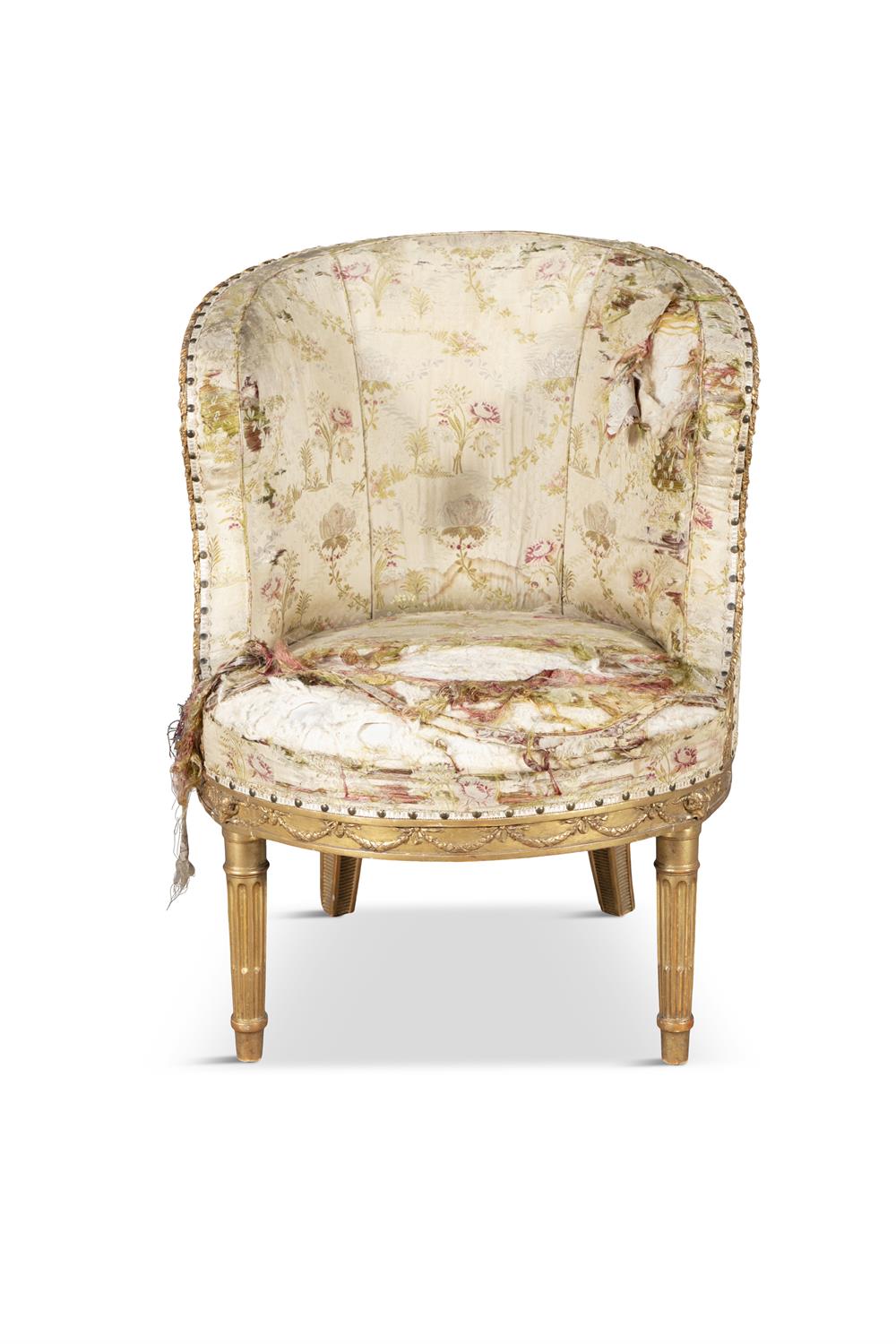 A LOUIS XVI CARVED GILTWOOD SMALL BERGERE, the silk upholstered back and arms with carved leaf