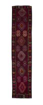 A WOOL RUNNER, IRAN, C.1970s, 434 x 92cm the central field woven with geometric motifs and