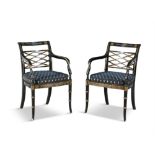 A PAIR OF EDWARDIAN EBONISED AND PARCEL GILT ARMCHAIRS, each with openwork lattice back,