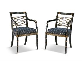 A PAIR OF EDWARDIAN EBONISED AND PARCEL GILT ARMCHAIRS, each with openwork lattice back,