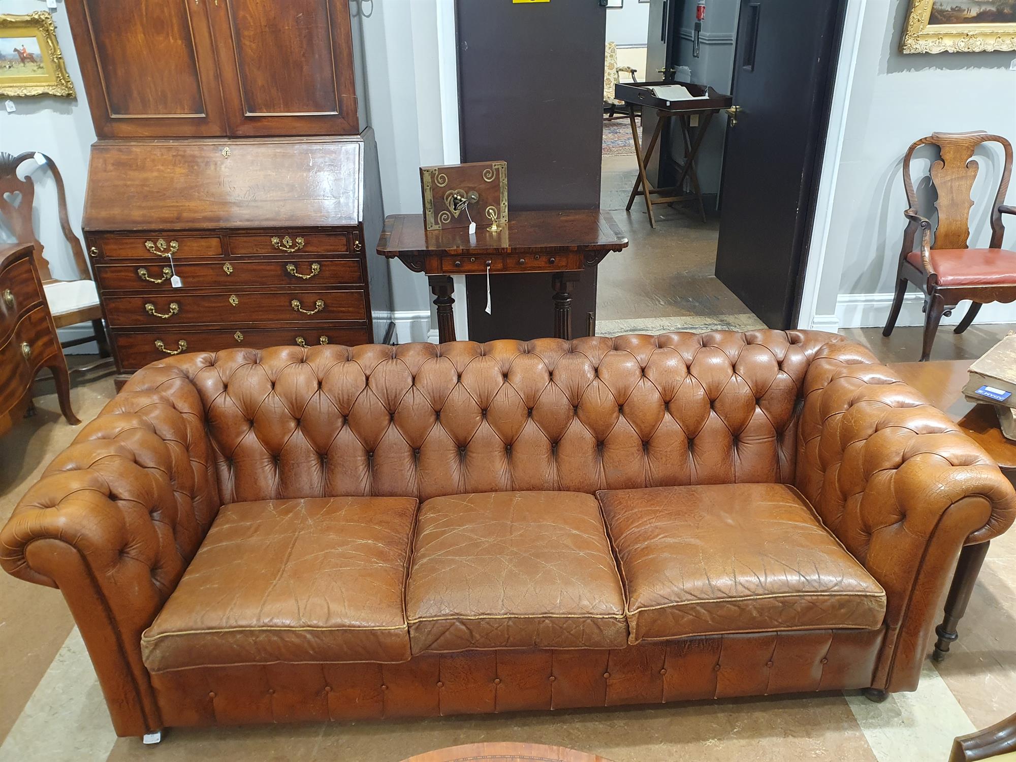 A CHESTERFIELD BUTTON BACK THREE SEATER SOFA, upholstered in brown leather with scroll-end - Image 7 of 18