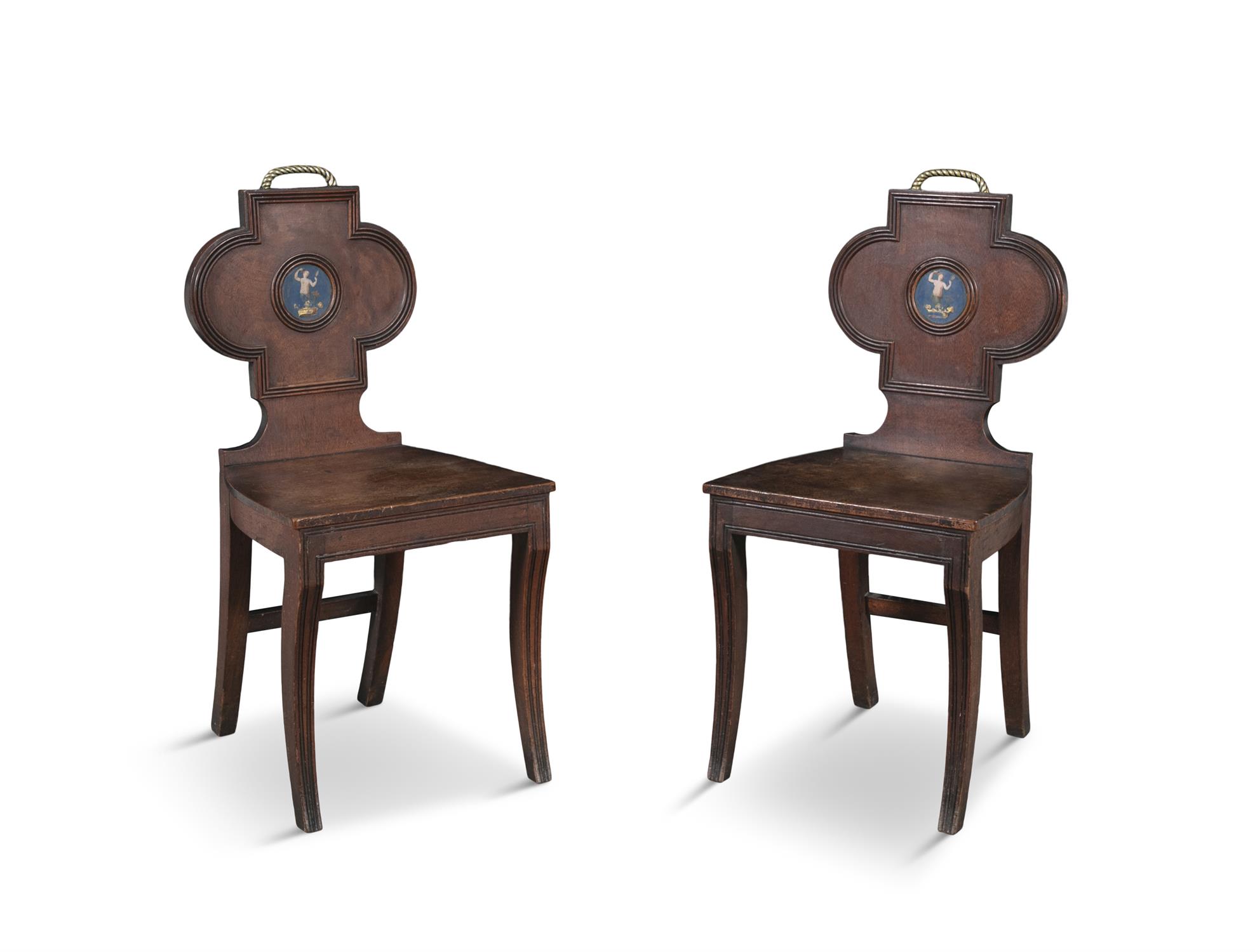 A PAIR OF REGENCY MAHOGANY HALL CHAIRS, each quatrefoil back with brass rope-twist handles