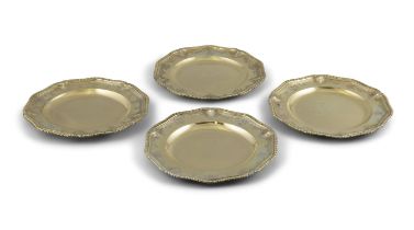 A SET OF FOUR GEORGE II SILVER GILT DINNER PLATES, London 1729, of shaped circular form,