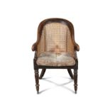 A REGENCY MAHOGANY BERGERE, EARLY 19TH CENTURY, with spoon shaped caned back with scroll arms,