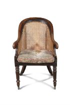 A REGENCY MAHOGANY BERGERE, EARLY 19TH CENTURY, with spoon shaped caned back with scroll arms,