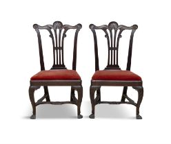 A PAIR OF IRISH MAHOGANY CHAIRS, C.1750, the waved crest rails accentuated with shell corners,