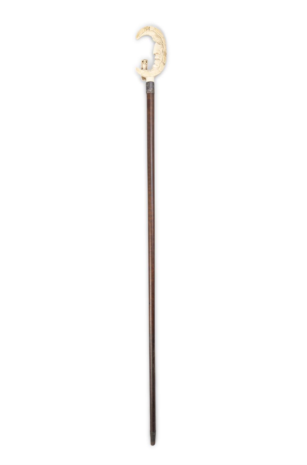 *A WALKING CANE with carved ivory top in the form of moon with the owl perched on its crescent,