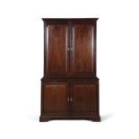 A GEORGE III MAHOGANY TWO-DOOR BOOKCASE, with moulded cavetto cornice above blind fielded panel
