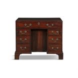 A GEORGE III MAHOGANY KNEEHOLE DESK, of rectangular shape, fitted with long drawer above a