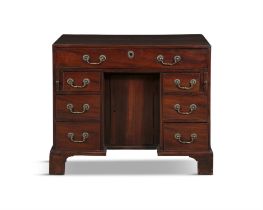 A GEORGE III MAHOGANY KNEEHOLE DESK, of rectangular shape, fitted with long drawer above a