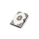 *AN IVORY CARD CASE, with applied metal scrollwork mounts, with crest reserve to centre,