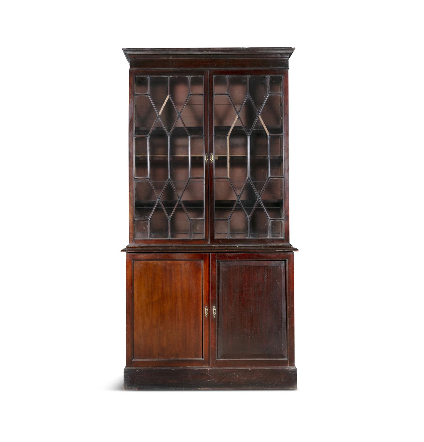 A GEORGE III MAHOGANY TWO-DOOR BOOKCASE, the rectangular top with cavetto cornice over twin
