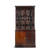 A GEORGE III MAHOGANY TWO-DOOR BOOKCASE, the rectangular top with cavetto cornice over twin