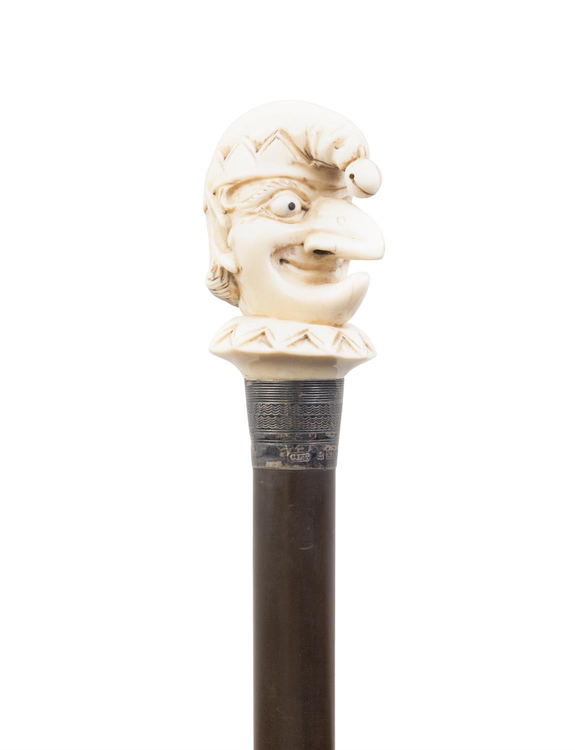 *A WALKING CANE, with a carved ivory handle in the shape of a Jester's head, with silver collar, - Image 2 of 2