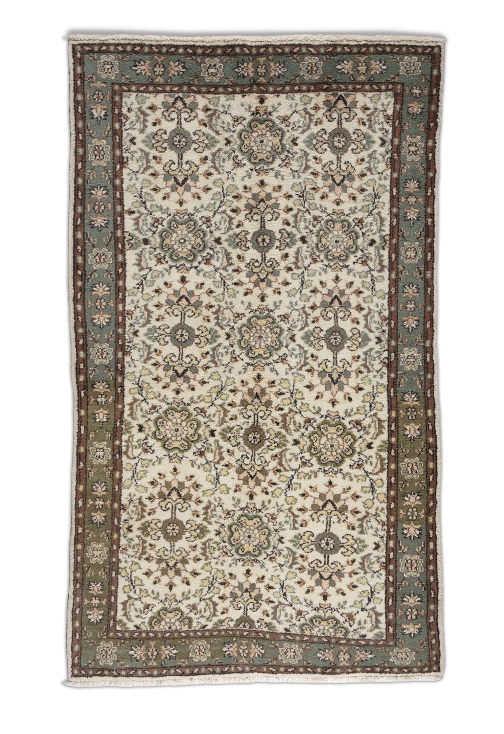 A TURKISH CREAM GROUND WOOL RUG, CA 1970s, 212 x 122cm the central field embroidered with flower