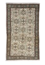 A TURKISH CREAM GROUND WOOL RUG, CA 1970s, 212 x 122cm the central field embroidered with flower