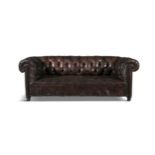 A BUTTONBACK BROWN LEATHER CHESTERFIELD SOFA of traditional design with out-scrolling arms and
