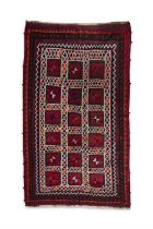 AN IRANIAN RED GROUND WOOL RUG, CA 1940s, 288 x 168cm the central field woven with three rows of