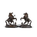 AFTER COUSTEAU, circa 1900, a pair of bronzed metal Marley horses, modelled as an attendant