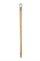 *A WALKING CANE, with a carved ivory 'fist handle' top in the shape of monkey's head,
