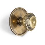A LARGE GEORGIAN STYLE DOOR KNOB 15cm diameter; together with a smaller brass door knob (2)