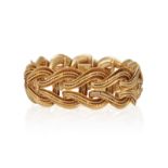 A GOLD BRACELET, FRENCH, CIRCA 1955 Of openwork design, the interlinked gathered hoops with