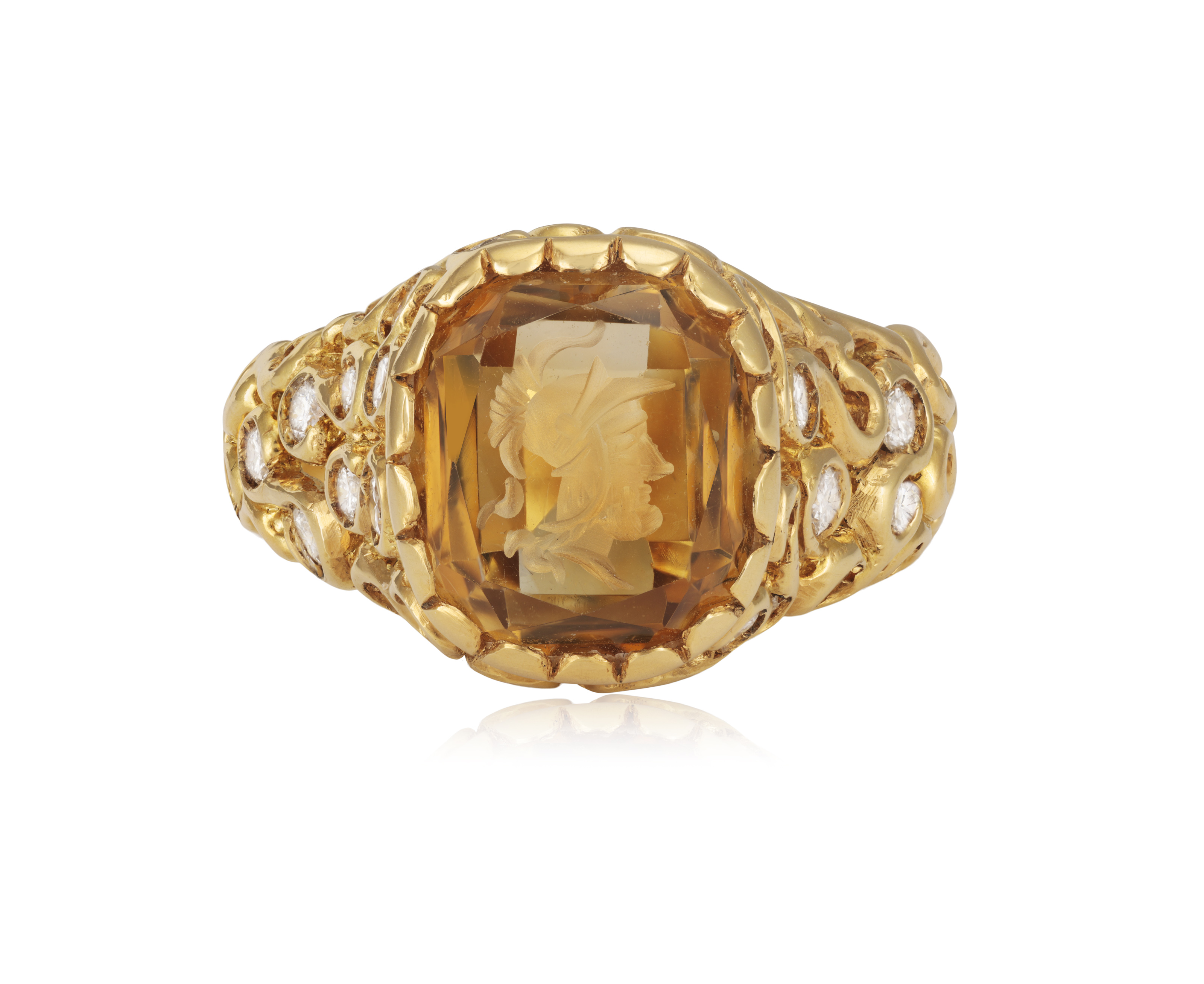 A DIAMOND AND CITRINE INTAGLIO RING The openwork scrolled raised mount, set with brilliant-cut