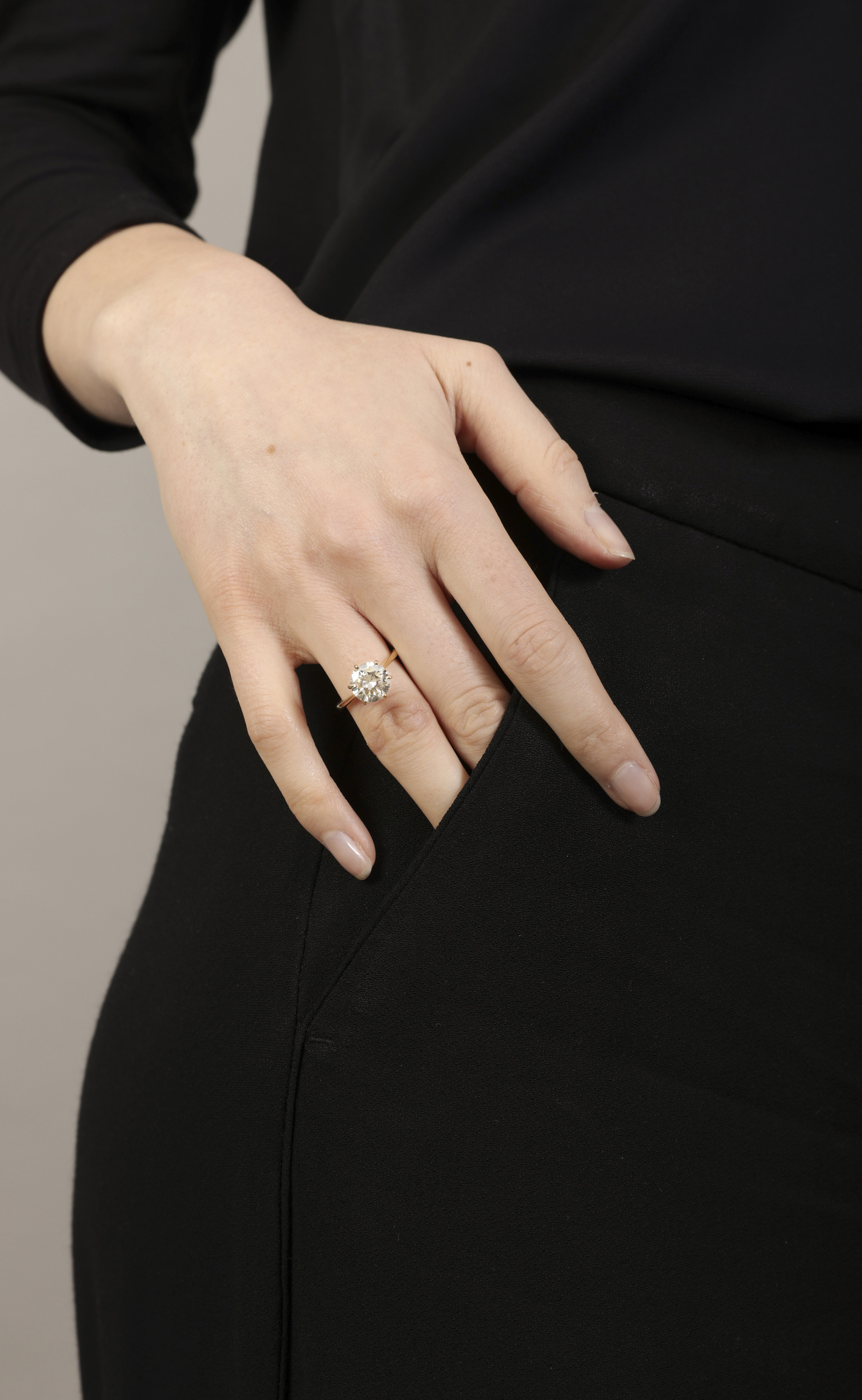 A DIAMOND SINGLE-STONE RING The brilliant-cut diamond within a six-claw setting, to a plain hoop, - Image 3 of 3