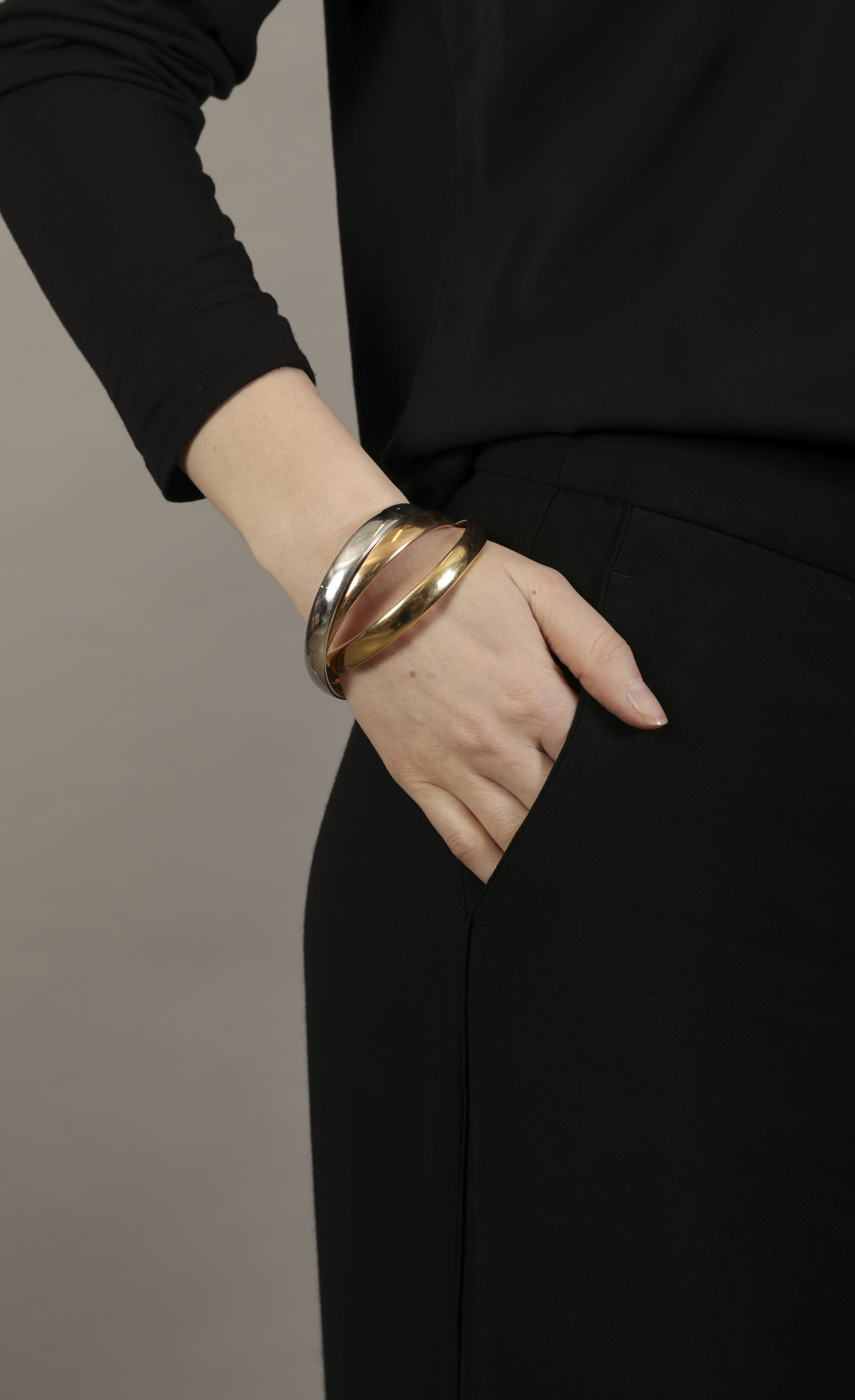 A GOLD 'TRINITY' BANGLE, BY CARTIER Composed of three interlocking polished 18K tri-coloured gold - Image 4 of 6