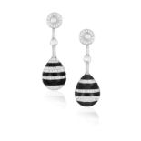 A PAIR OF DIAMOND AND ONYX EARRINGS Of opposing design, each drop-shaped motif set with carved
