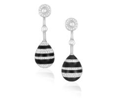 A PAIR OF DIAMOND AND ONYX EARRINGS Of opposing design, each drop-shaped motif set with carved