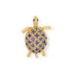 A SAPPHIRE NOVELTY BROOCH, BY CARTIER, CIRCA 1960 Designed as a turtle, the shell set with