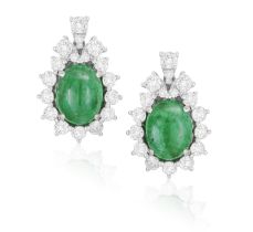 A PAIR OF EMERALD AND DIAMOND EARRINGS Each oval-shaped emerald cabochon within a surround of