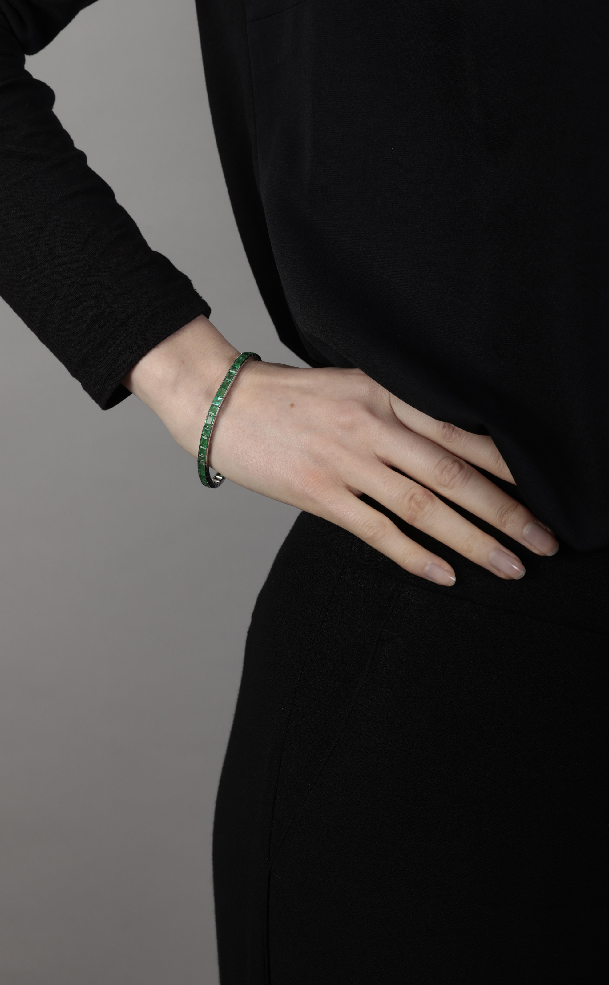 AN EMERALD LINE BRACELET Composed of a continuous line of rectangular-cut emeralds, mounted in 18K - Image 3 of 3