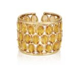 A CITRINE AND DIAMOND CUFF-BRACELET Of wide openwork design, set with oval-shaped citrines within