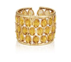 A CITRINE AND DIAMOND CUFF-BRACELET Of wide openwork design, set with oval-shaped citrines within