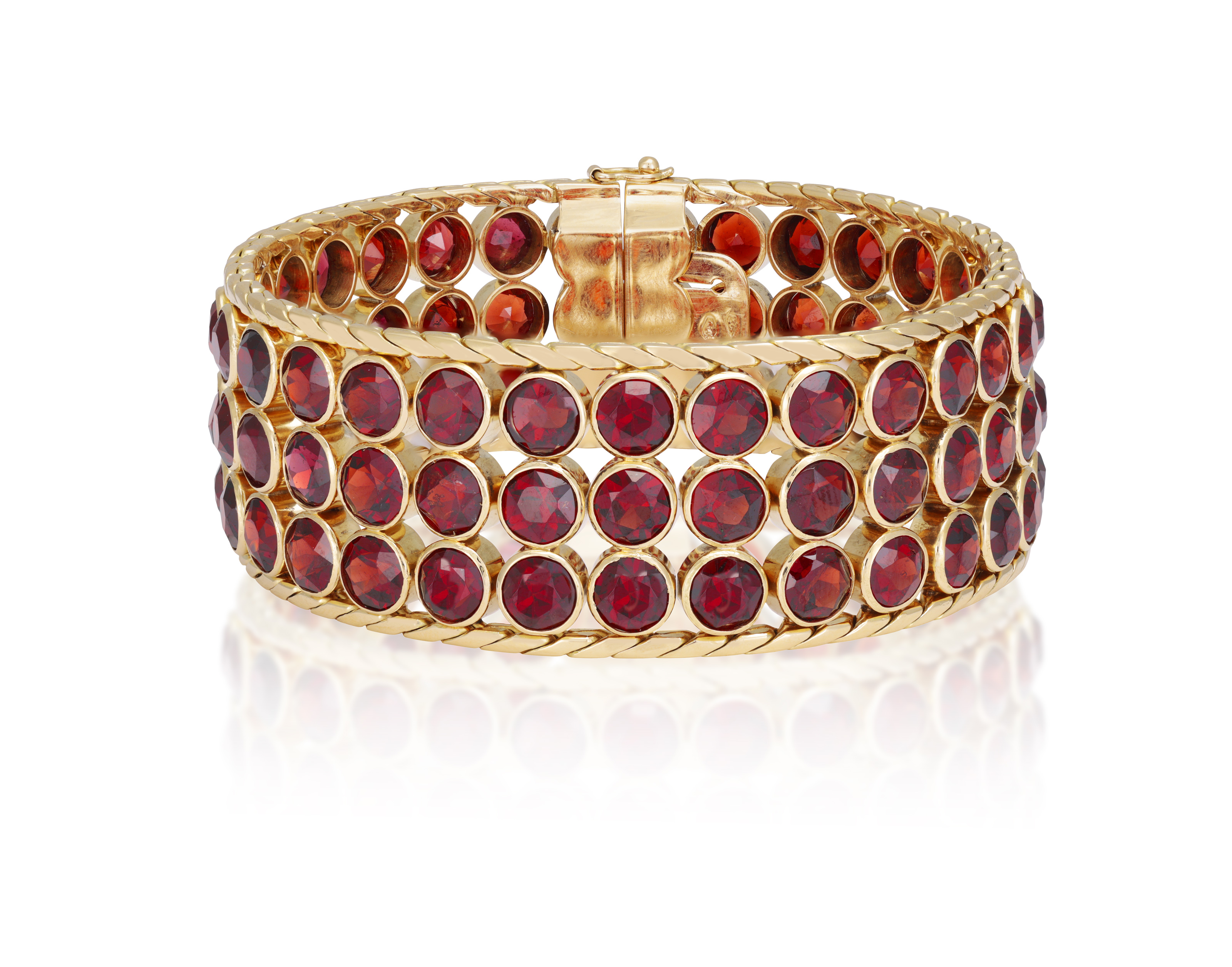 A GARNET AND GOLD BRACELET, CIRCA 1950 The wide band collet-set with circular-cut garnets, to fine- - Image 3 of 4