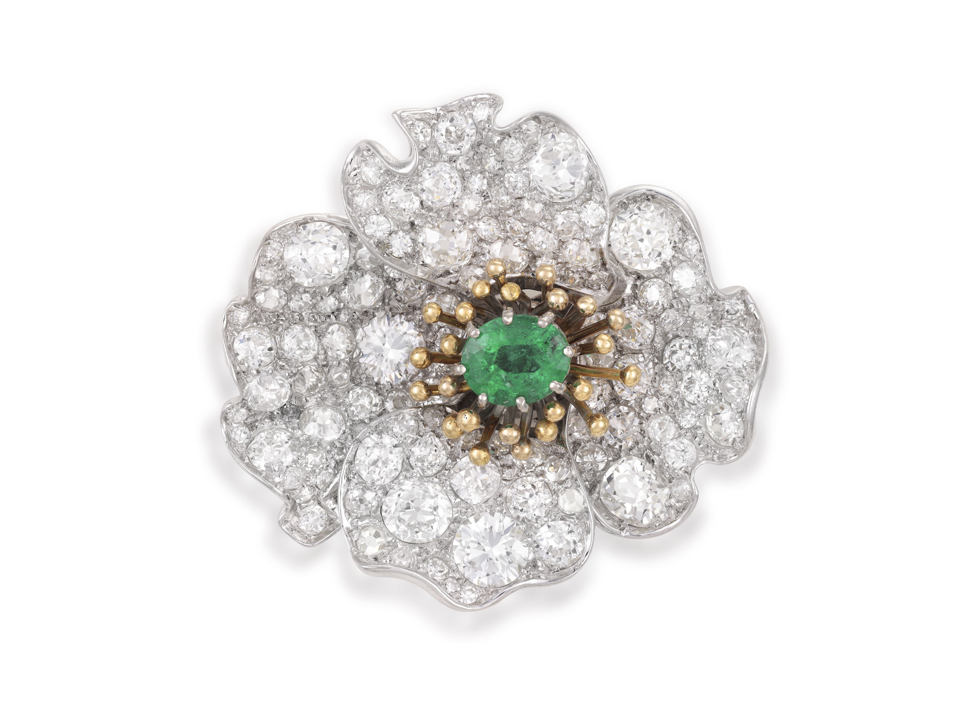 A LATE 19TH/ EARLY 20TH CENTURY EMERALD AND DIAMOND BROOCH Designed as a stylised flowerhead,