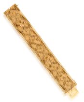 A GOLD BRACELET, FRENCH, CIRCA 1965 The textured and polished strap designed to resemble embroidery,