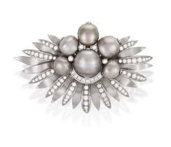 A CULTURED PEARL AND DIAMOND BROOCH, CIRCA 1960 Of fan-shaped palm design, centring a cultured pearl