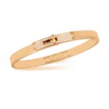 AN 18K GOLD AND DIAMOND 'KELLY BRACELET' BY HERMÈS The polished oval gold bangle with 'Kelly' turn-