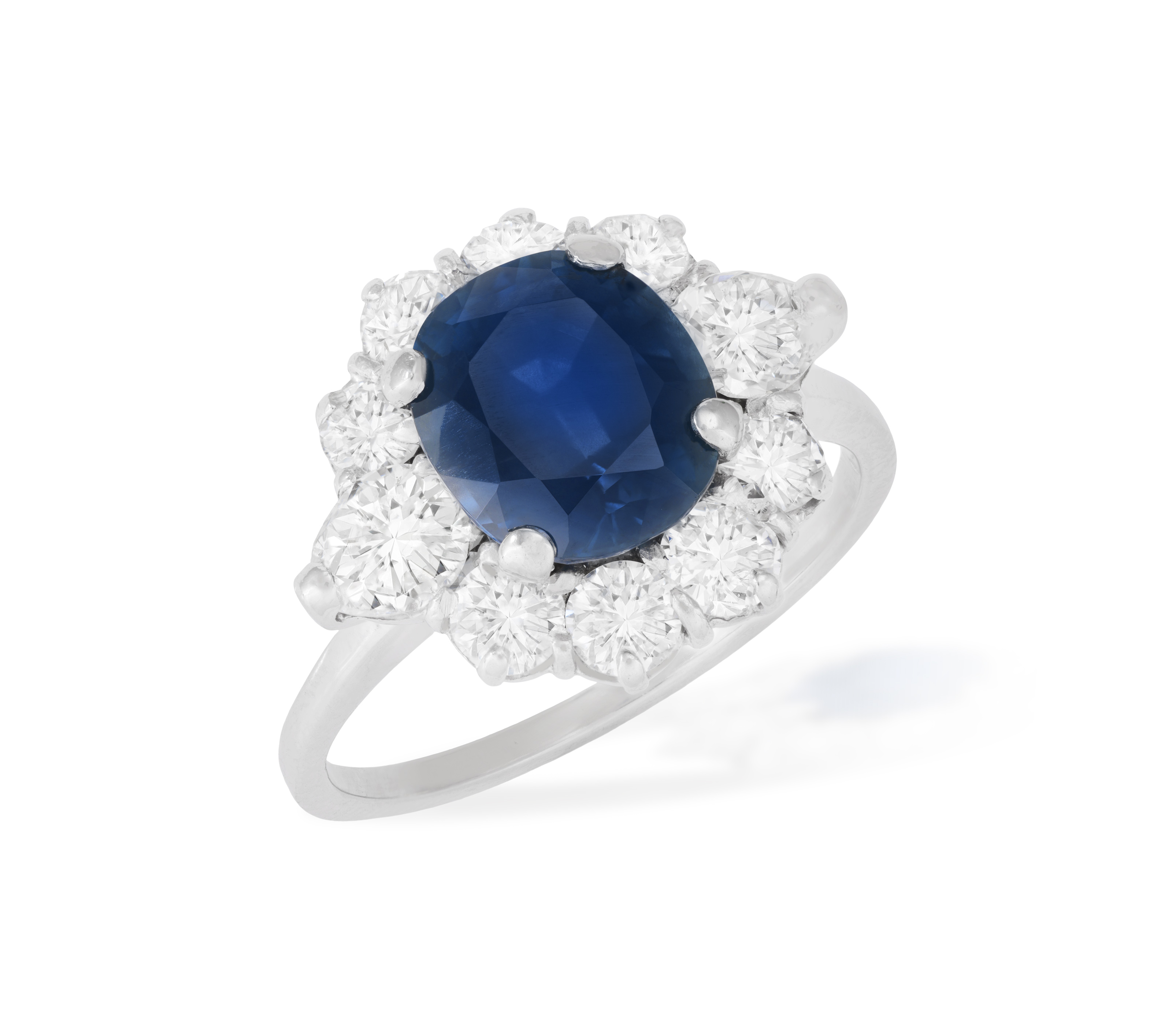 A SAPPHIRE AND DIAMOND CLUSTER RING The cushion-shaped sapphire weighing approximately 3.99cts, - Image 2 of 4