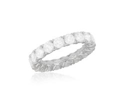 A DIAMOND ETERNITY RING Composed of a continuous row of brilliant-cut diamonds within claw-